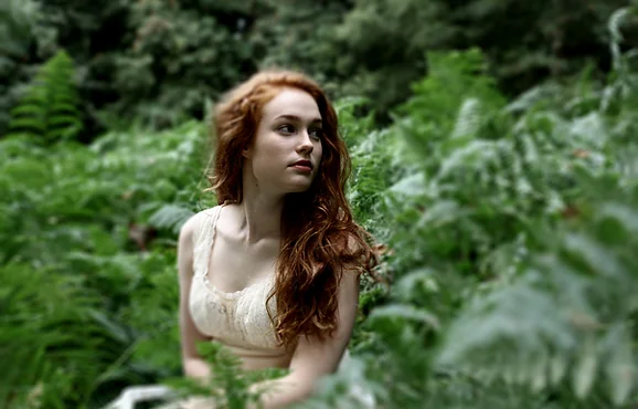 Cat in the forest, in a long pale dress